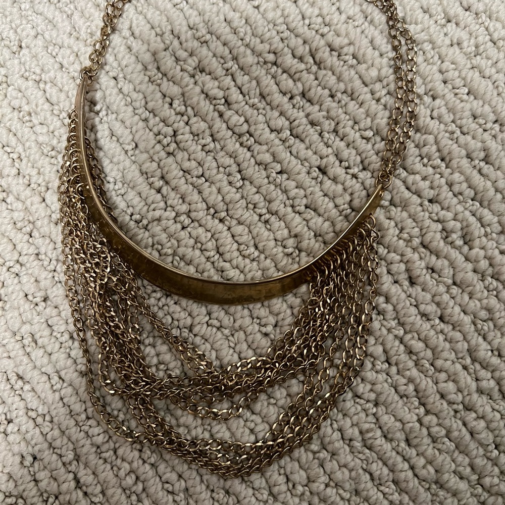 Gold necklace choker style with layers of thinner necklace